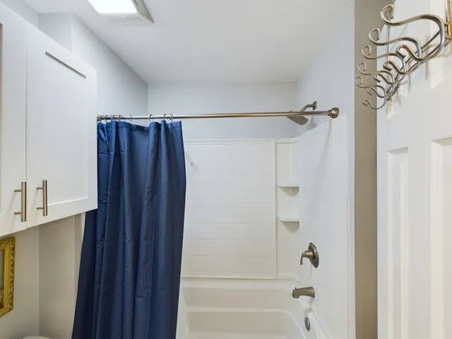 a bathroom with a shower and a tub