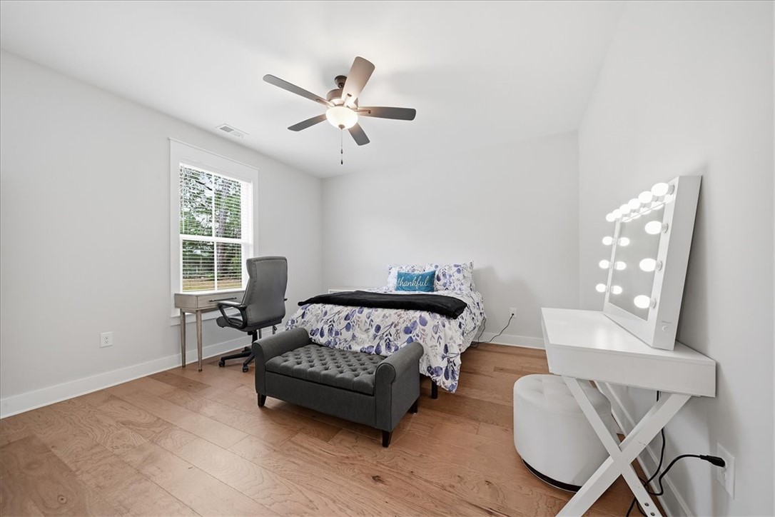 214 Timothy Court Anderson, SC 29621 - Photo 20 of 43 Hardwood floors and a window view elevate this cozy sleeping space.