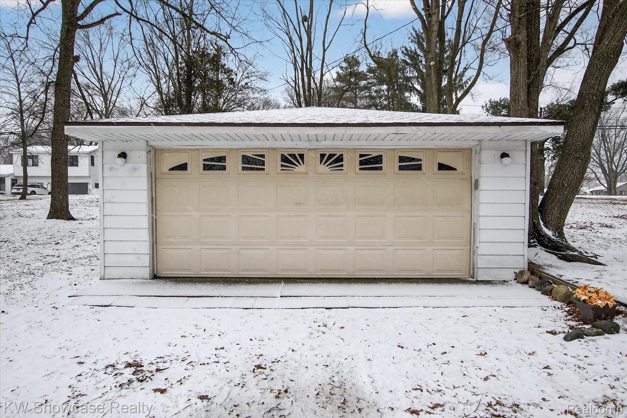1860 Ladd Road Walled Lake, MI 48390 - Photo 32 of 48 Snow covered garage featuring a garage