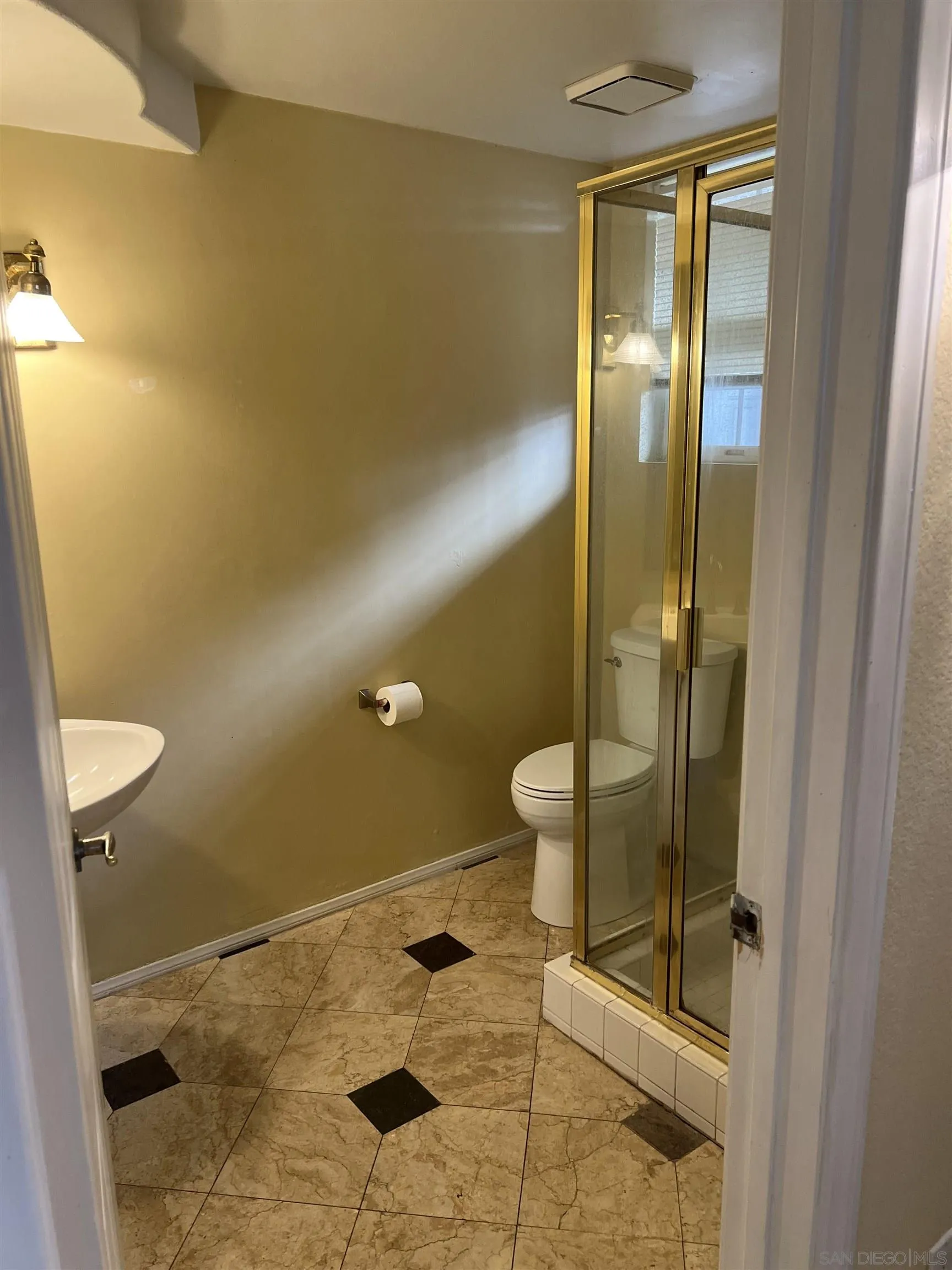 2834 Torrey Pines Road La Jolla, CA 92037 - Photo 3 of 15 a bathroom with a granite countertop toilet and a sink