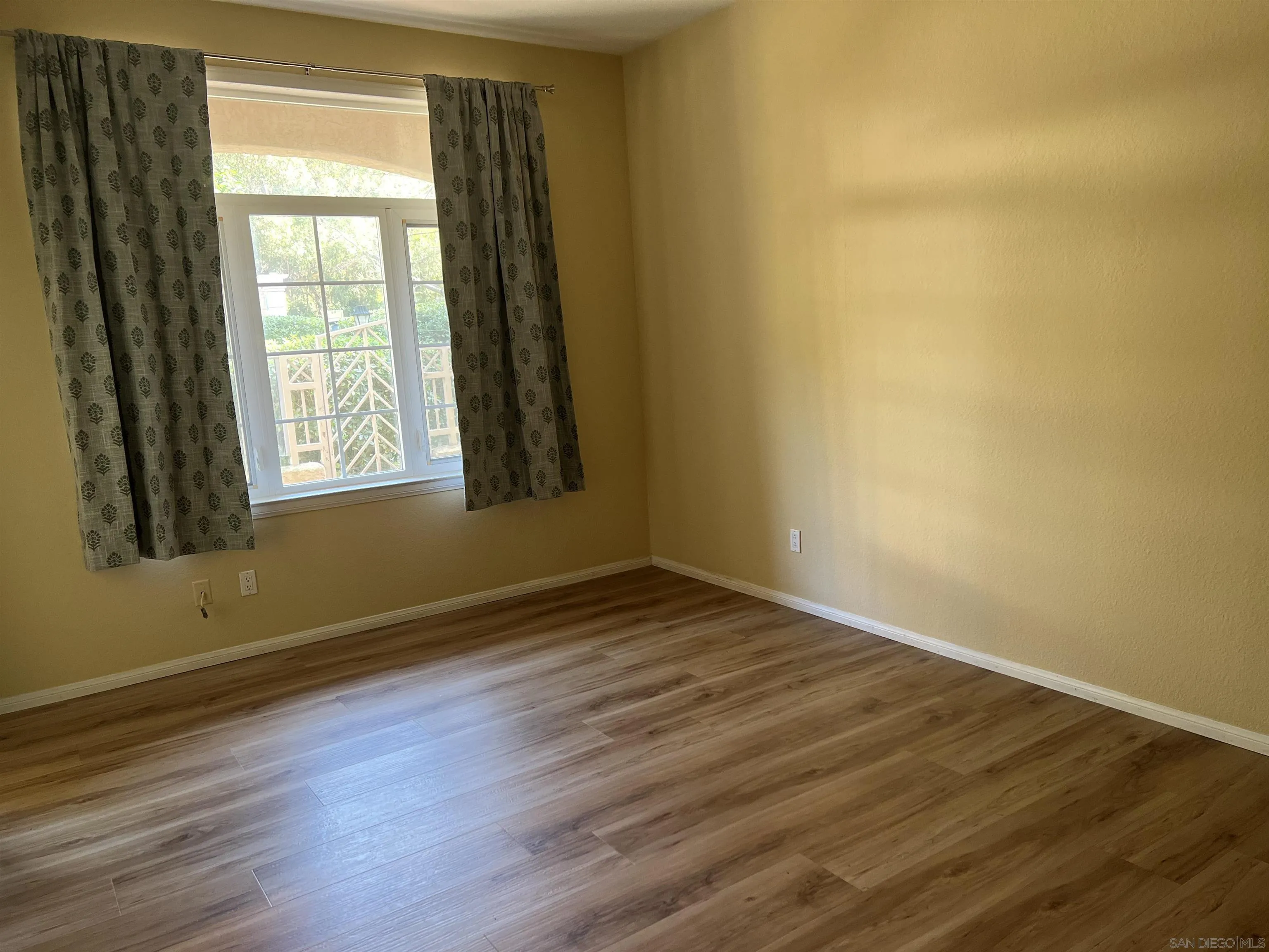 2834 Torrey Pines Road La Jolla, CA 92037 - Photo 7 of 15 a view of an empty room with wooden floor and a window