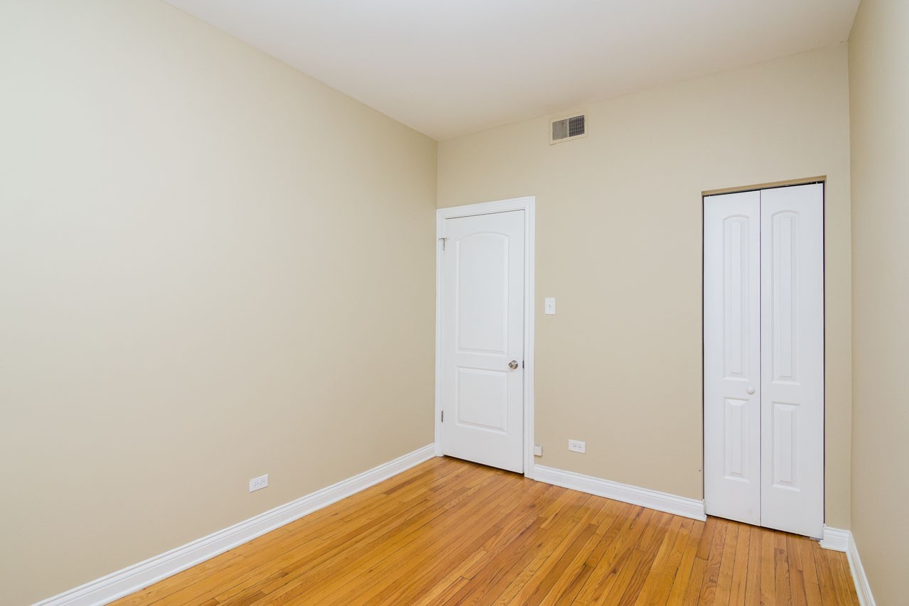4437 West Fullerton Avenue, Unit 3 Chicago, IL 60639 - Photo 5 of 9 a view of an empty room with wooden floor