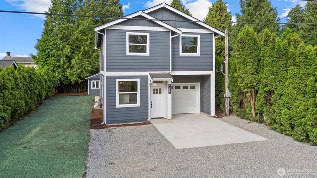 a front view of a house with a yard and garage
