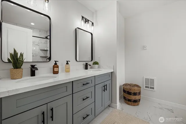a bathroom with a double vanity sink and a mirror
