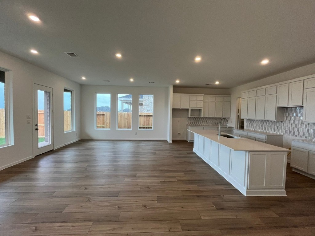4411 Eagle Pass Drive Rosenberg, TX 77469 - Photo 30 of 33 a large kitchen with lots of counter space wooden floor and windows