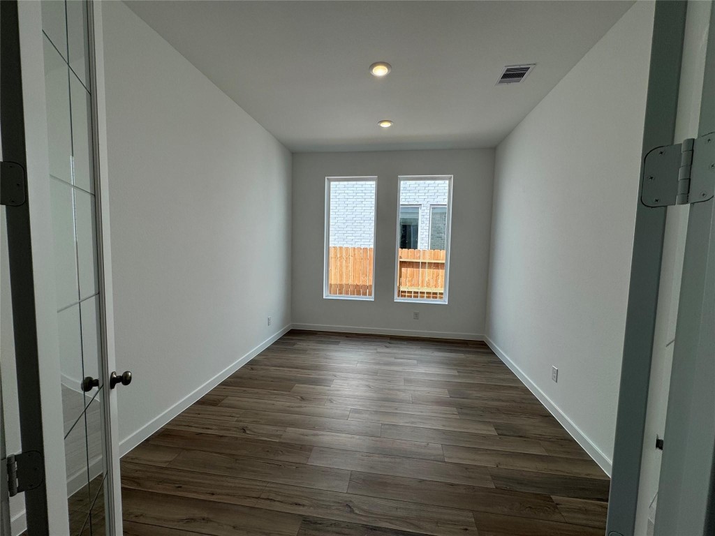 4411 Eagle Pass Drive Rosenberg, TX 77469 - Photo 6 of 33 a view of an empty room with wooden floor and a window