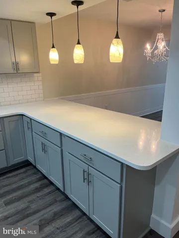 a view of a kitchen with wooden floor and a large window