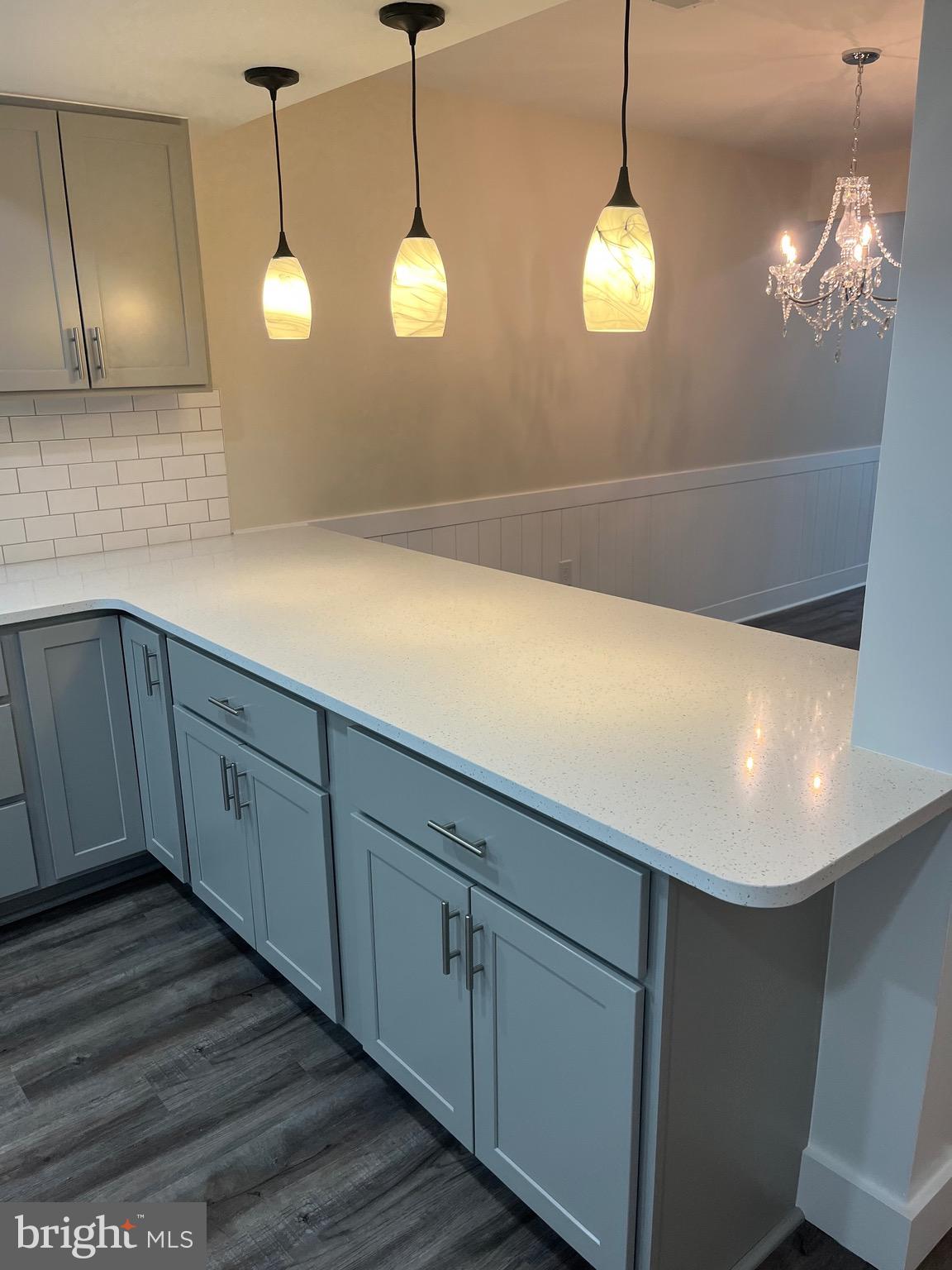 163 Jamestown Road Ocean City, MD 21842 - Photo 4 of 8 a view of a kitchen with wooden floor and a large window