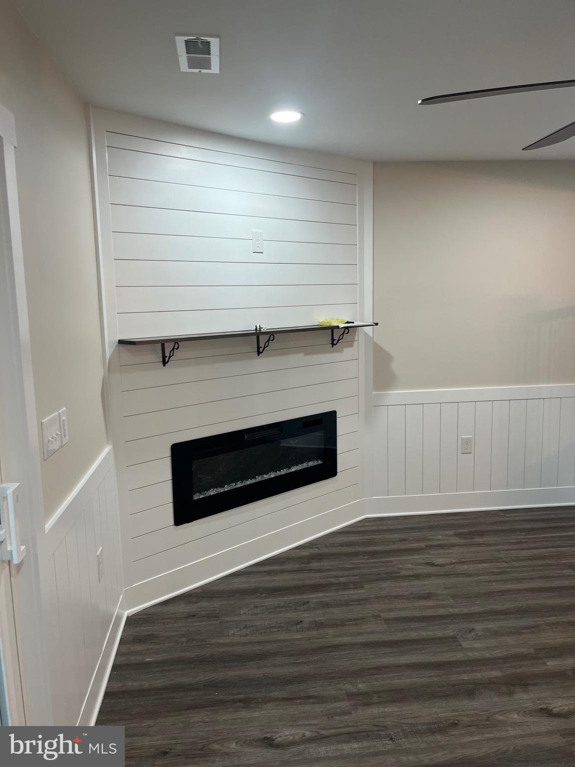 163 Jamestown Road Ocean City, MD 21842 - Photo 6 of 8 a living room with hard wood floors and a fireplace