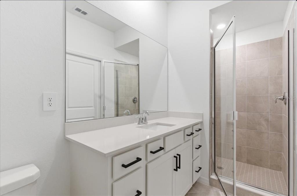 19140 Scallop Loop, Unit 308 Lakewood Ranch, FL 34211 - Photo 11 of 19 a bathroom with a sink and a mirror