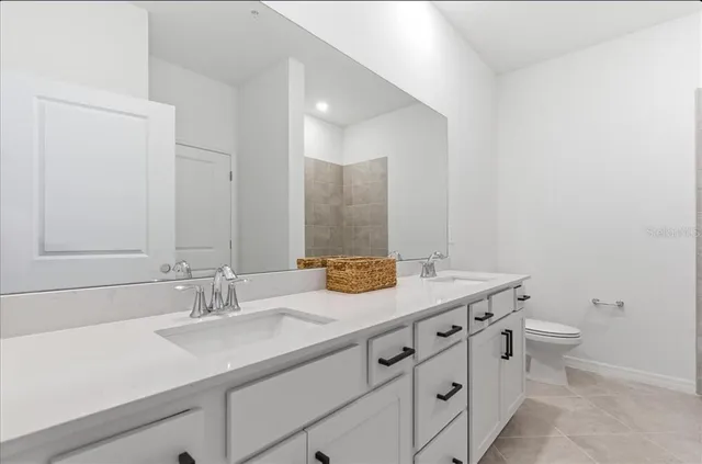 a white bath tub sitting next to a bathroom sink