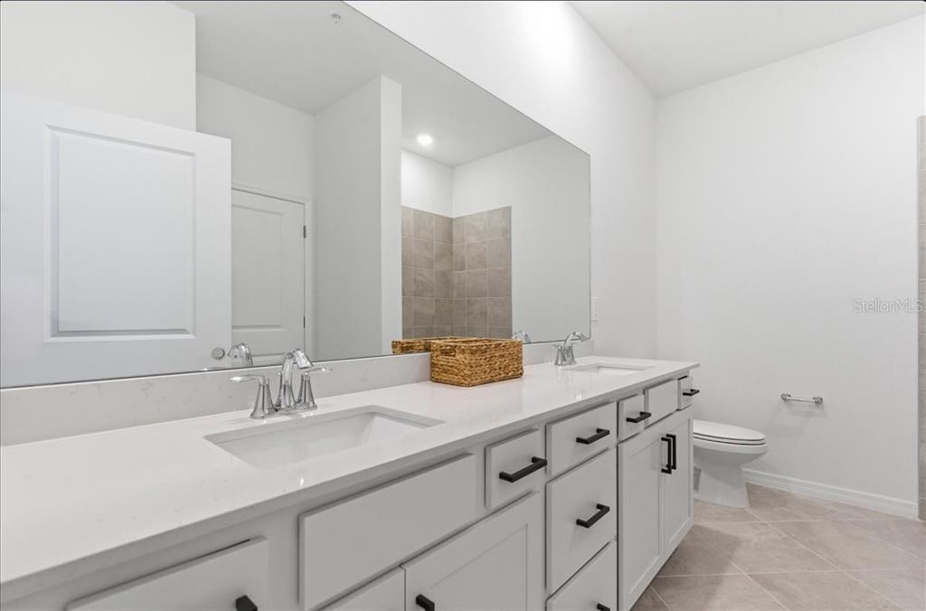 19140 Scallop Loop, Unit 308 Lakewood Ranch, FL 34211 - Photo 14 of 19 a bathroom with a sink and a mirror