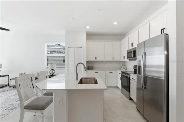 a kitchen with a refrigerator and a sink