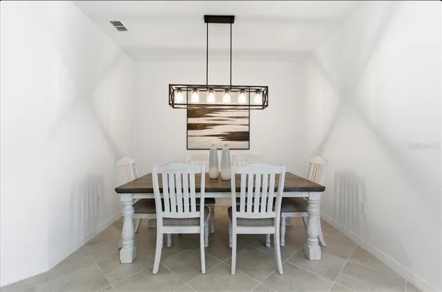 a view of a dining room with furniture window and chandelier