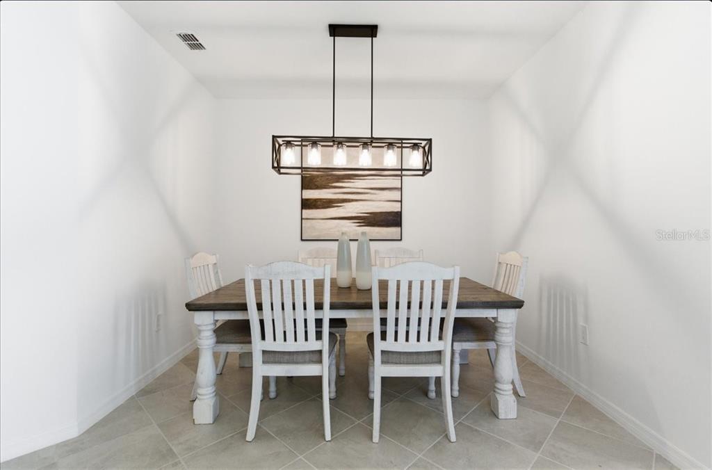 19140 Scallop Loop, Unit 308 Lakewood Ranch, FL 34211 - Photo 4 of 19 a view of a dining room with furniture window and chandelier