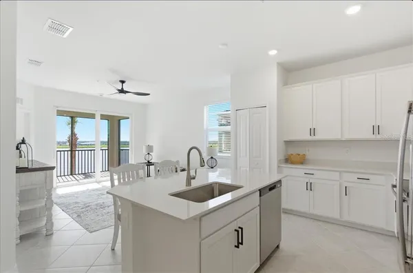a kitchen with granite countertop a sink and cabinets