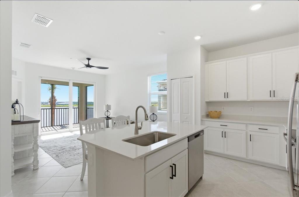 19140 Scallop Loop, Unit 308 Lakewood Ranch, FL 34211 - Photo 7 of 19 a kitchen with granite countertop a sink and cabinets