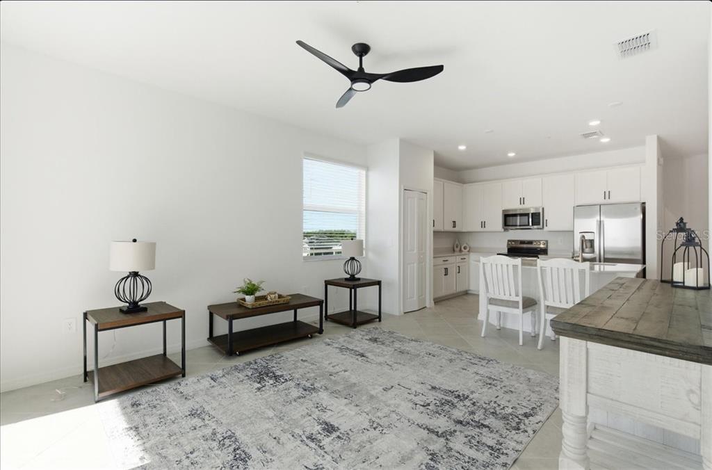 19140 Scallop Loop, Unit 308 Lakewood Ranch, FL 34211 - Photo 10 of 19 a living room with furniture and kitchen view