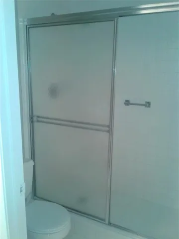 a bathroom with a toilet and a shower