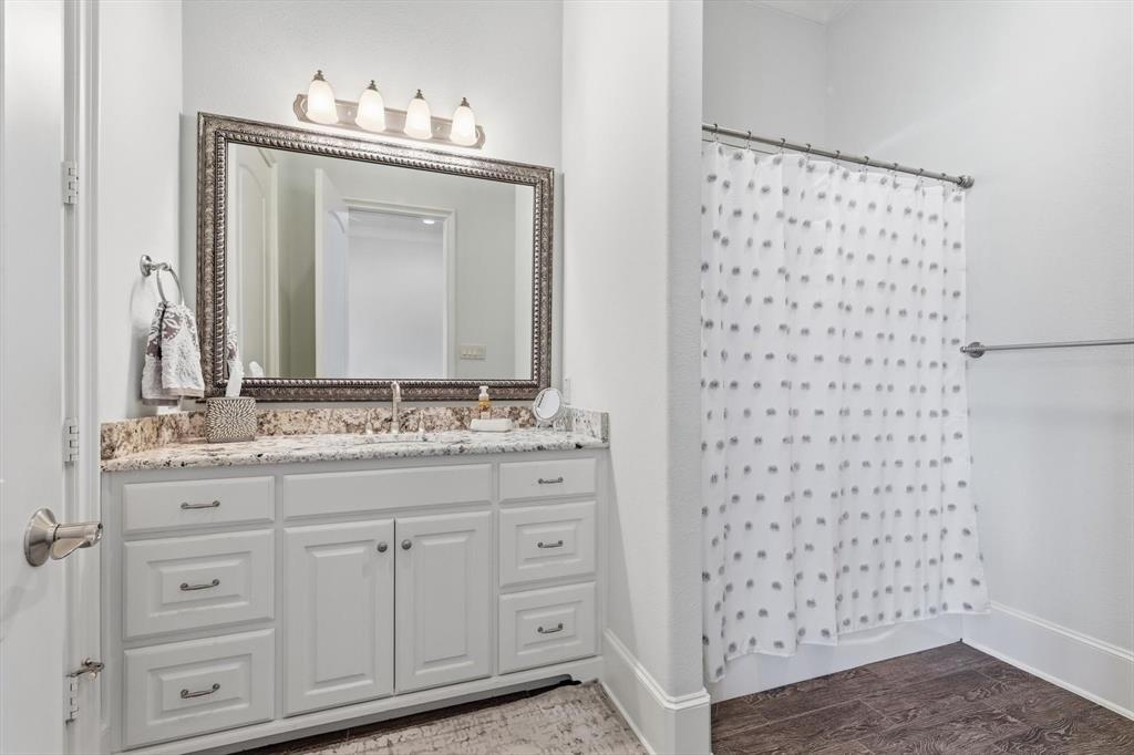 476 Hidden Valley Lane Coppell, TX 75019 - Photo 33 of 40 a bathroom with a sink a vanity and a mirror