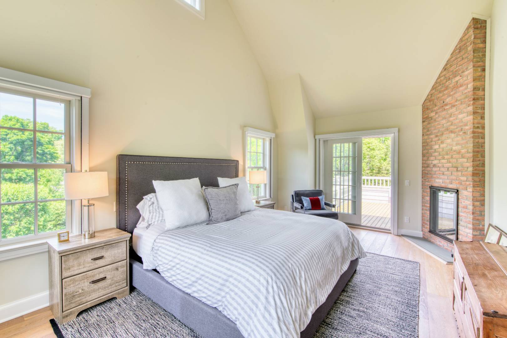 69 Harrison Street Sag Harbor, NY 11963 - Photo 12 of 17 a spacious bedroom with a bed and a large window