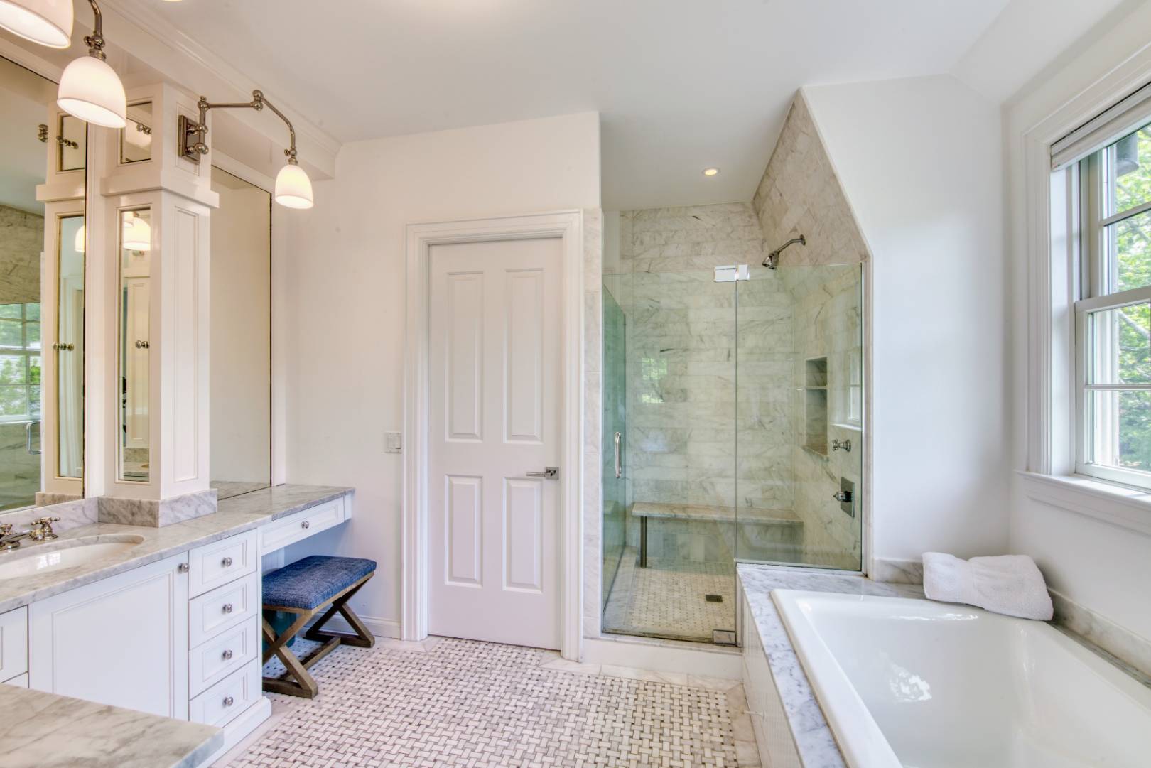 69 Harrison Street Sag Harbor, NY 11963 - Photo 13 of 17 a spacious bathroom with a granite countertop tub sink a mirror a shower and vanity