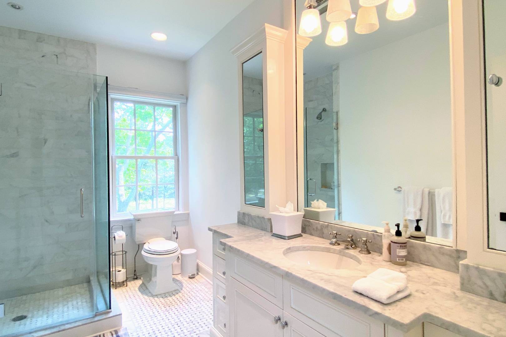 69 Harrison Street Sag Harbor, NY 11963 - Photo 16 of 17 a bathroom with a granite countertop double vanity sink a mirror and a shower