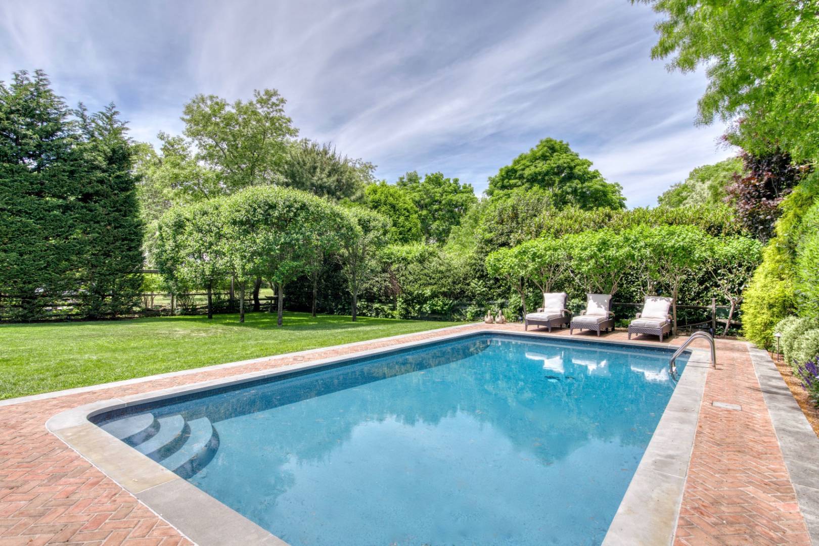 69 Harrison Street Sag Harbor, NY 11963 - Photo 2 of 17 a view of a swimming pool and a yard