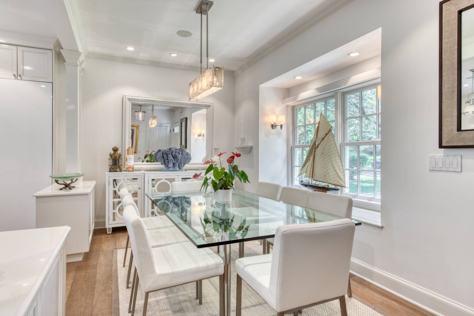 69 Harrison Street Sag Harbor, NY 11963 - Photo 6 of 17 a dining room with furniture a chandelier and wooden floor