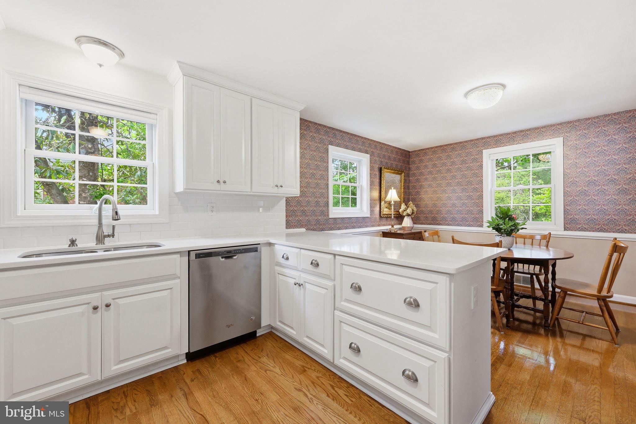 7601 Hollins Road Henrico, VA 23229 - Photo 11 of 47 a kitchen with sink cabinets and wooden floor