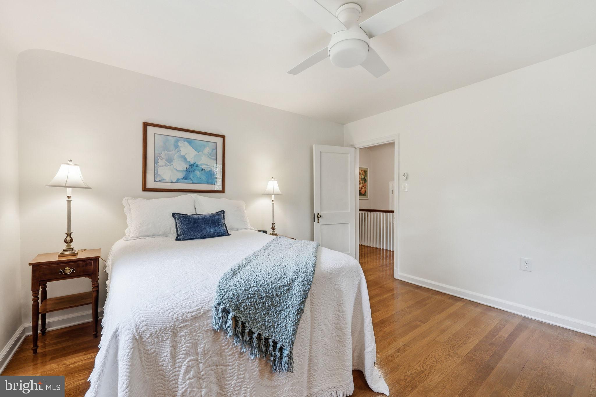 7601 Hollins Road Henrico, VA 23229 - Photo 18 of 47 a spacious bedroom with a bed and a chandelier