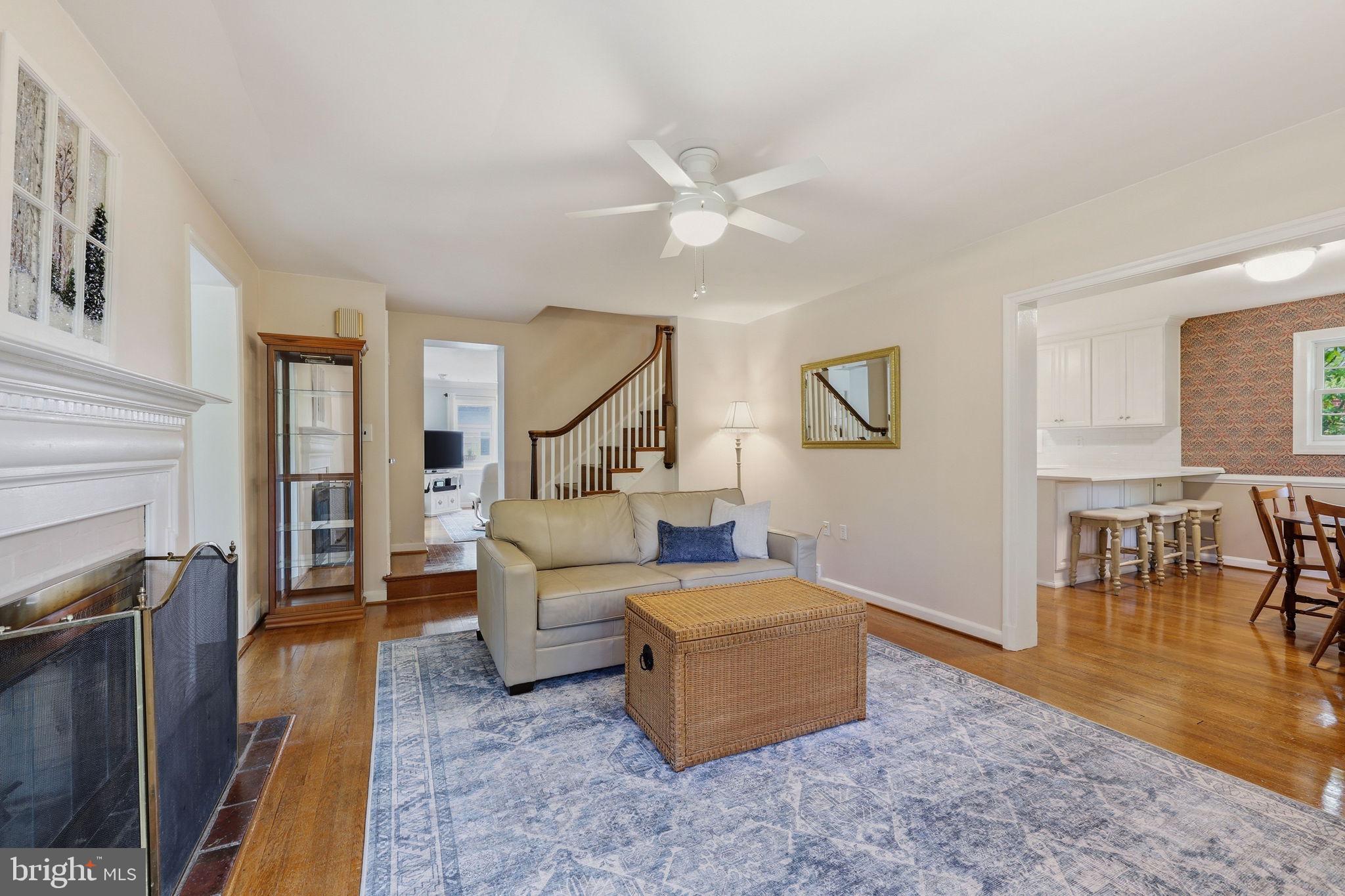 7601 Hollins Road Henrico, VA 23229 - Photo 4 of 47 a living room with furniture and a dining table with wooden floor