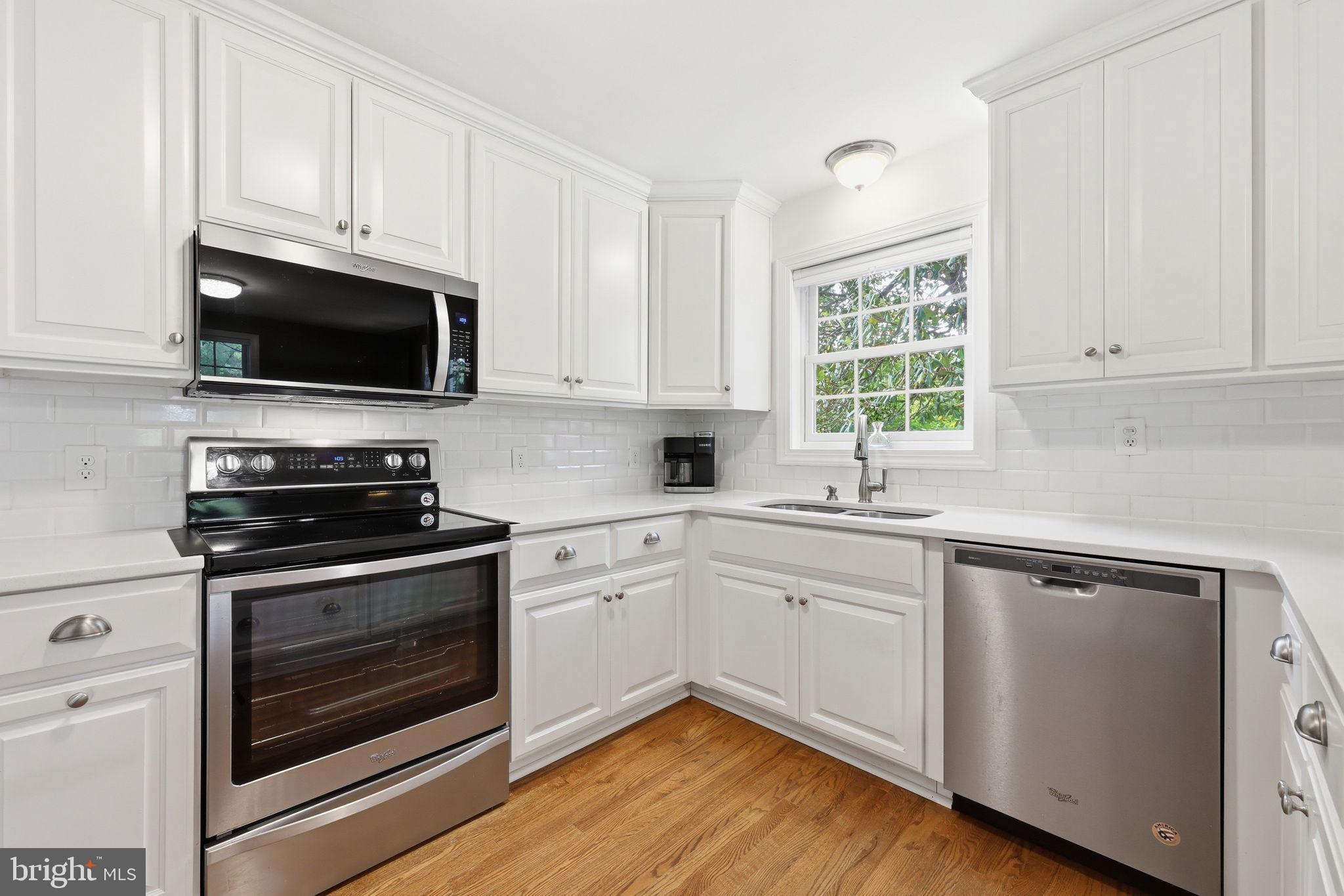 7601 Hollins Road Henrico, VA 23229 - Photo 10 of 47 a kitchen with cabinets stainless steel appliances a sink and a window