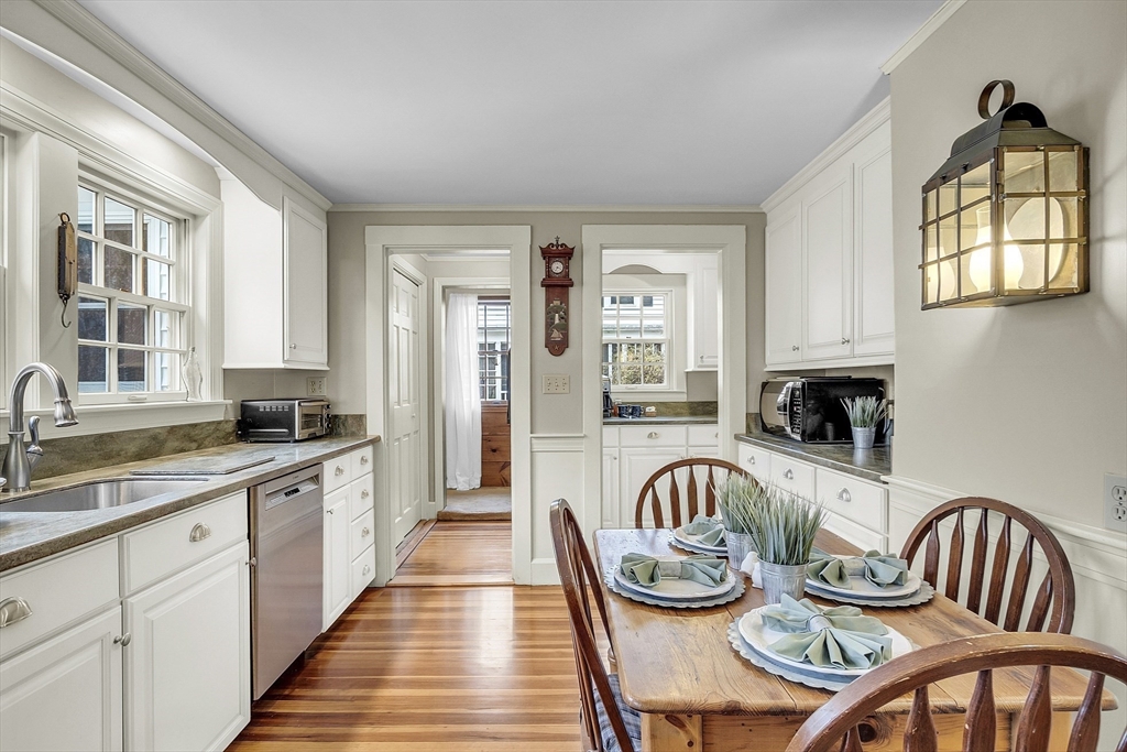 9 Carlisle Street Andover, MA 01810 - Photo 12 of 42 a kitchen with stainless steel appliances a table and chairs