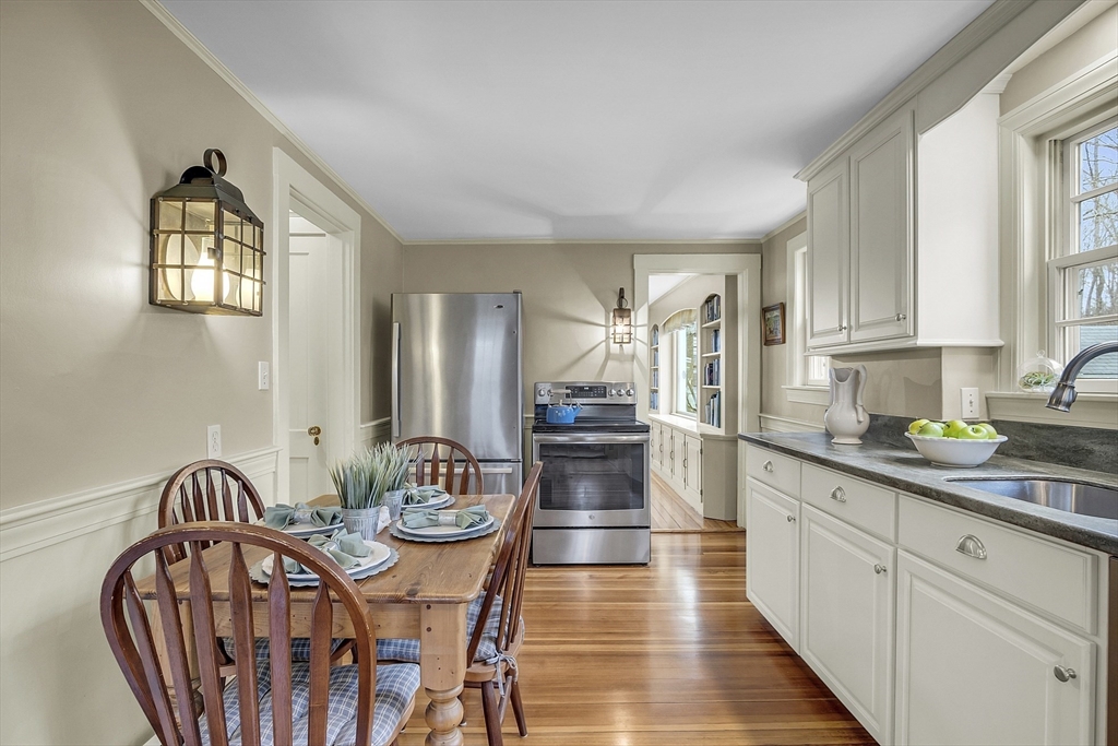 9 Carlisle Street Andover, MA 01810 - Photo 13 of 42 a kitchen with furniture wooden floor and stainless steel appliances