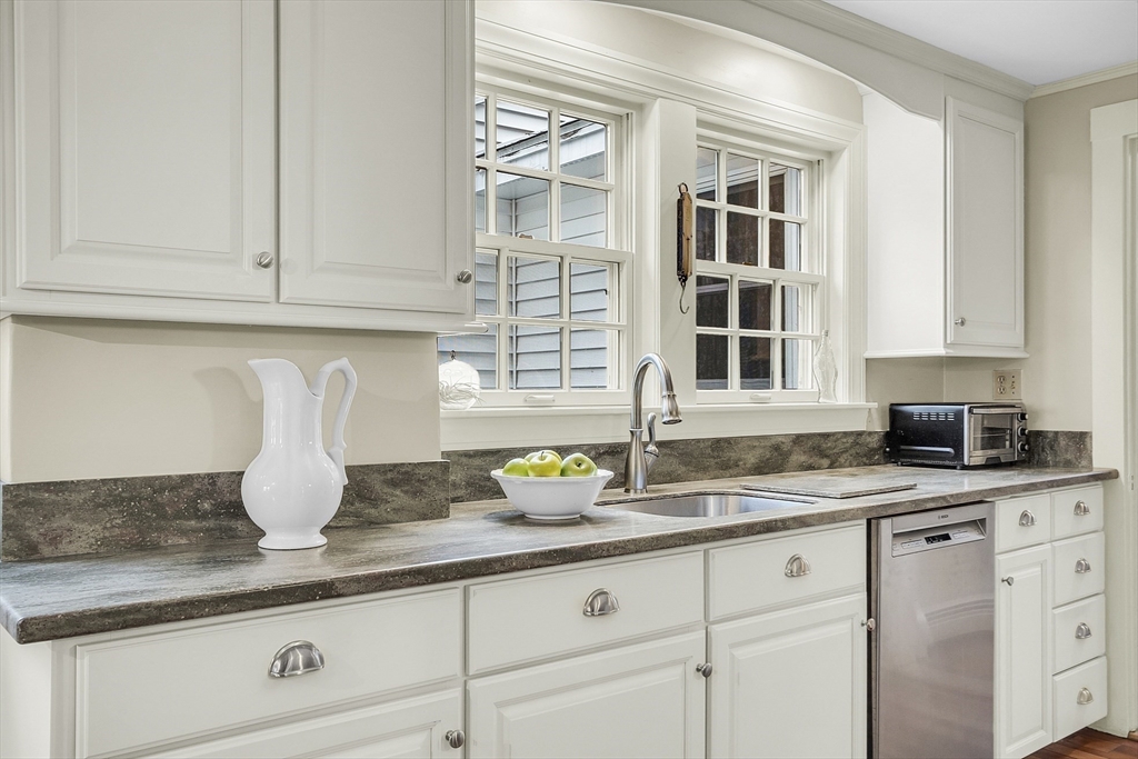 9 Carlisle Street Andover, MA 01810 - Photo 14 of 42 a kitchen with granite countertop white cabinets and sink