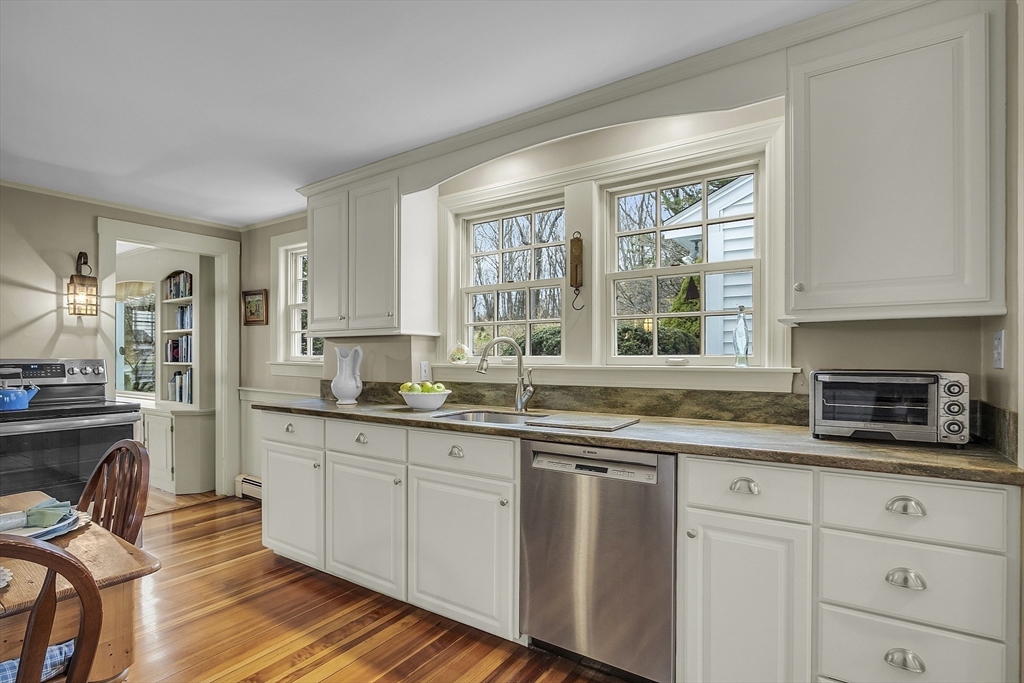 9 Carlisle Street Andover, MA 01810 - Photo 15 of 42 a kitchen with stainless steel appliances granite countertop a stove a sink and white cabinets