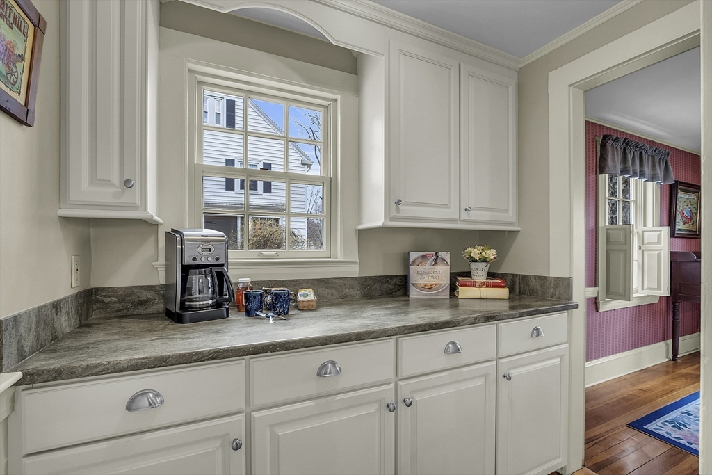 9 Carlisle Street Andover, MA 01810 - Photo 16 of 42 a kitchen with granite countertop stainless steel appliances a sink window and cabinets
