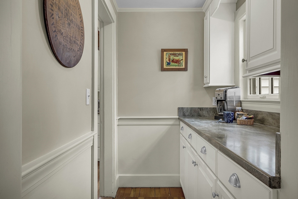 9 Carlisle Street Andover, MA 01810 - Photo 17 of 42 a bathroom with a granite countertop sink a mirror and vanity