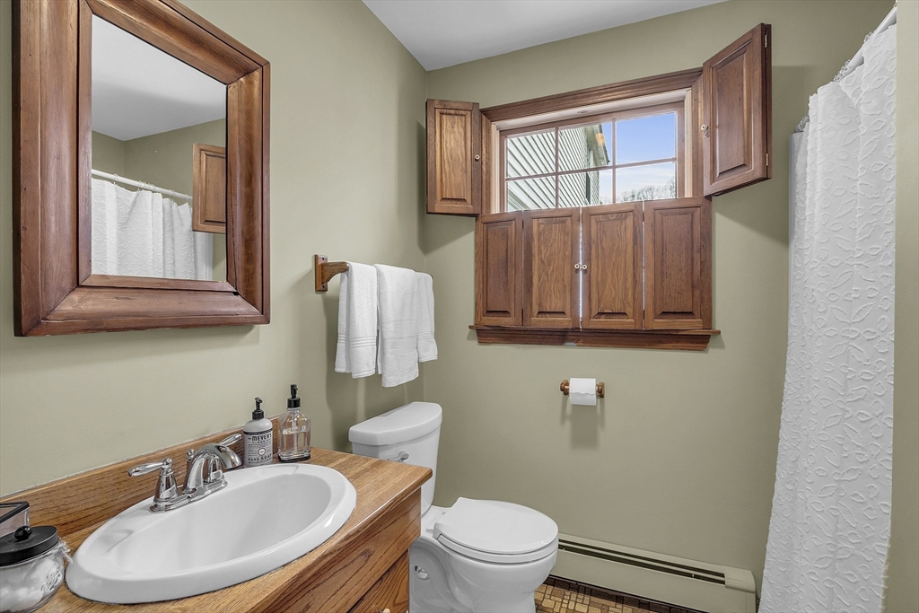 9 Carlisle Street Andover, MA 01810 - Photo 23 of 42 a bathroom with a toilet a sink and mirror