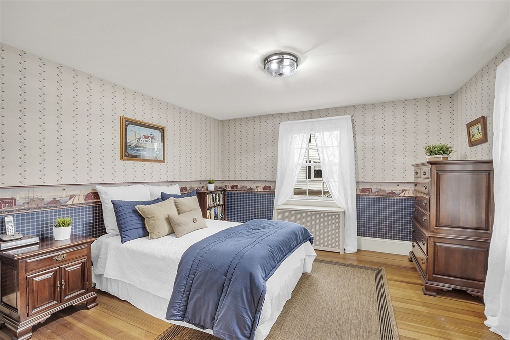 9 Carlisle Street Andover, MA 01810 - Photo 28 of 42 a bedroom with a bed and wooden floor