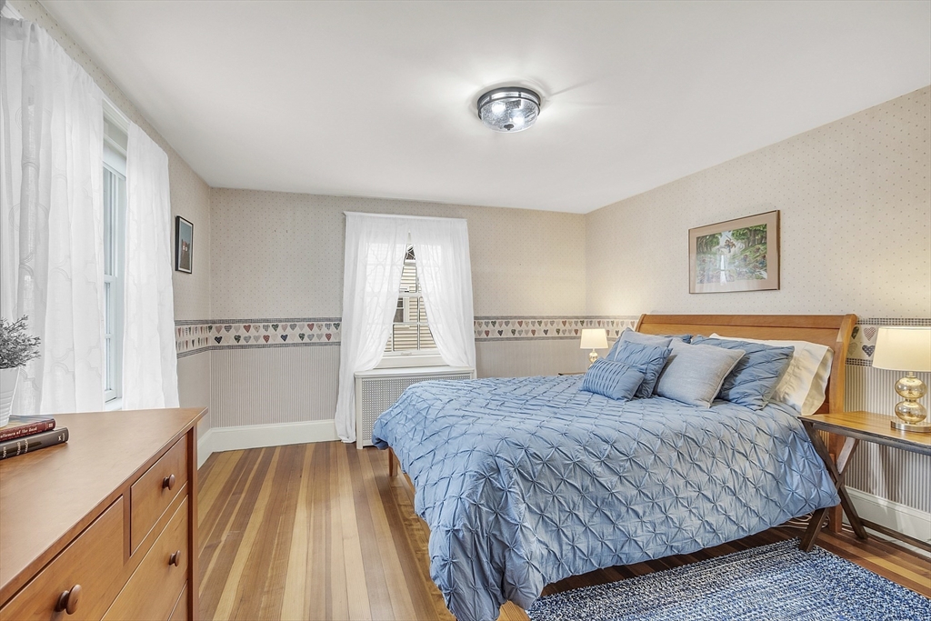 9 Carlisle Street Andover, MA 01810 - Photo 30 of 42 a bedroom with a large bed and a chandelier