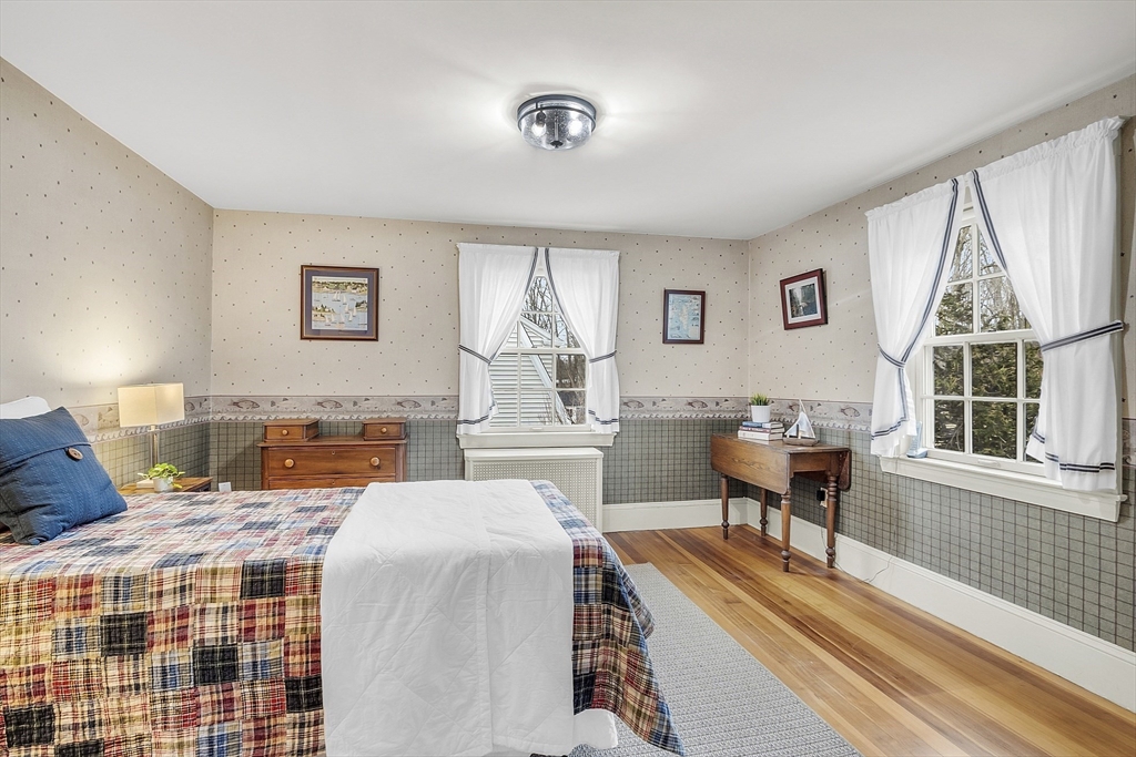 9 Carlisle Street Andover, MA 01810 - Photo 34 of 42 a bedroom with a bed and a desk next to a window