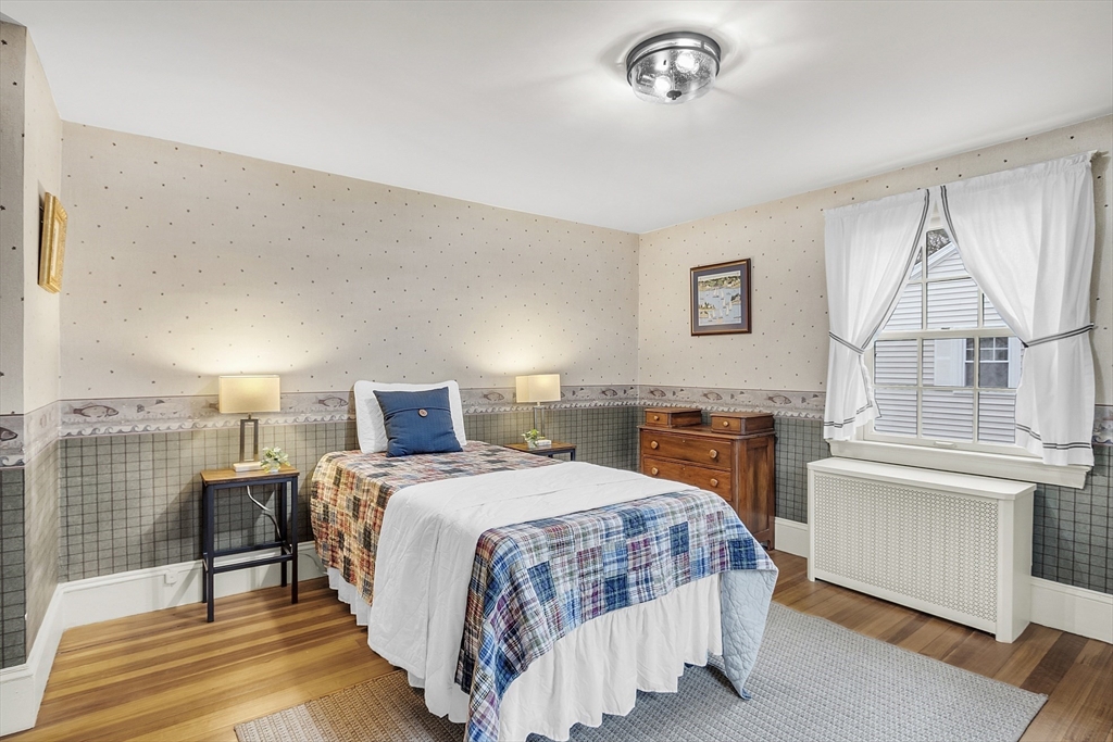 9 Carlisle Street Andover, MA 01810 - Photo 35 of 42 a bedroom with a bed and a table