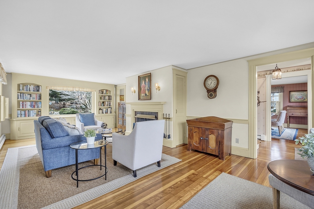 9 Carlisle Street Andover, MA 01810 - Photo 5 of 42 a living room with furniture a fireplace and a floor to ceiling window