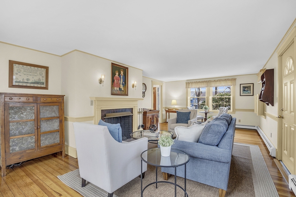 9 Carlisle Street Andover, MA 01810 - Photo 6 of 42 a living room with furniture a fireplace and a table