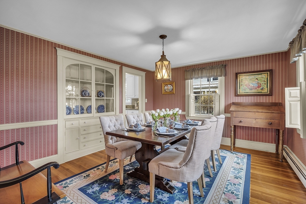 9 Carlisle Street Andover, MA 01810 - Photo 9 of 42 a dining room with furniture a chandelier and wooden floor