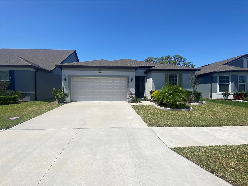 a front view of a house with a yard and garage