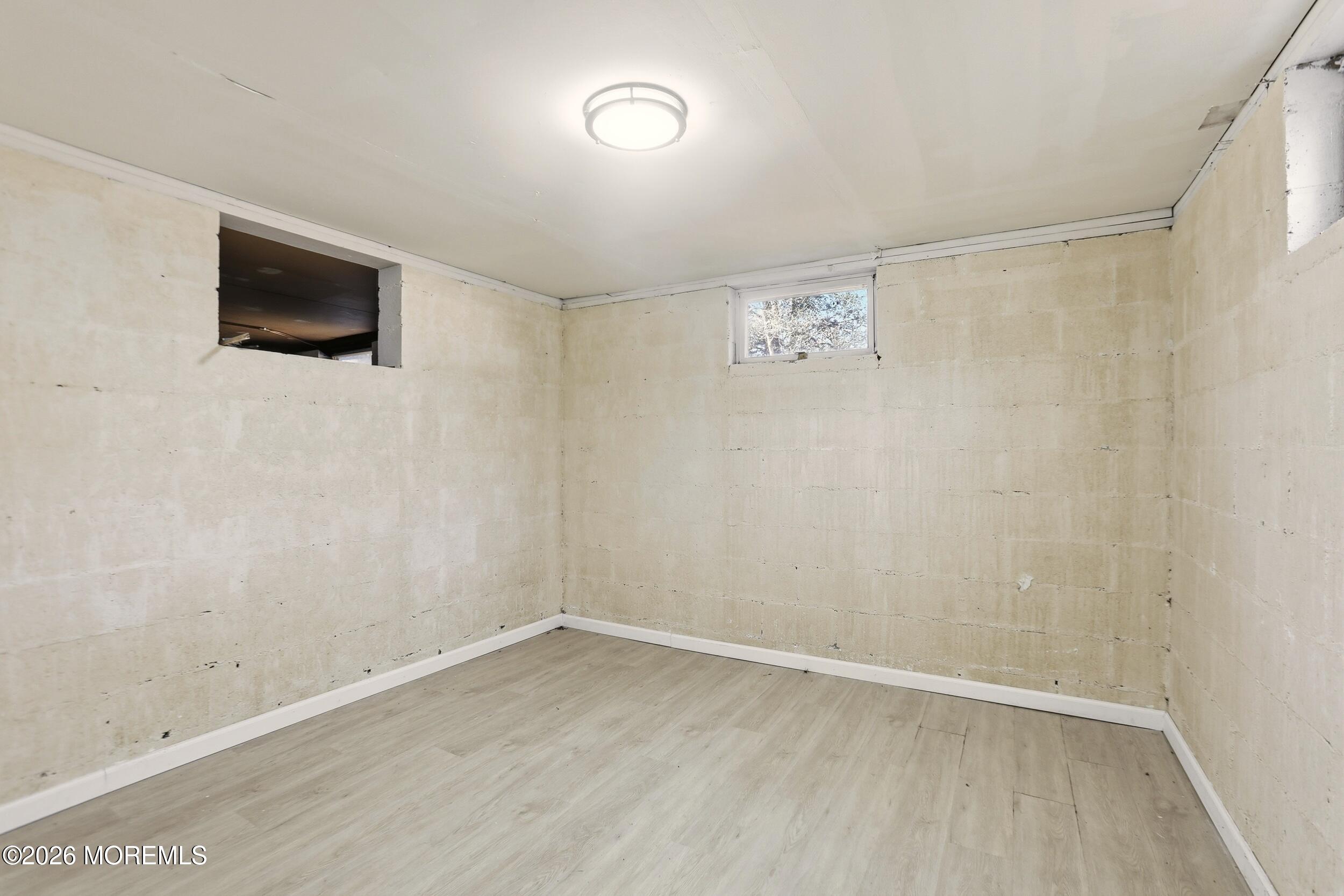 9 Riccis Drive Jackson, NJ 08527 - Photo 14 of 30 a view of an empty room with wooden floor and a window