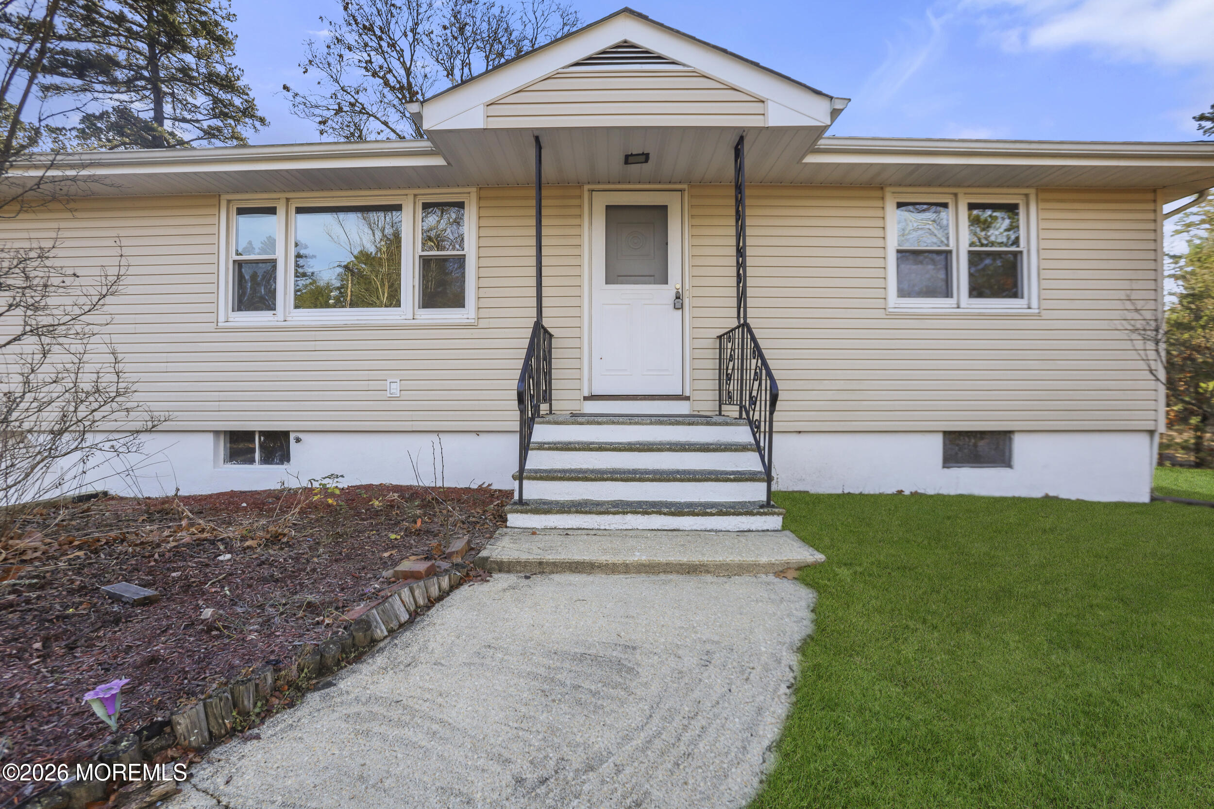 9 Riccis Drive Jackson, NJ 08527 - Photo 15 of 30 a front view of a house with a yard and garage